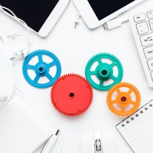 workflow-and-teamwork-concepts-with-colorful-gears-and-different-gadgets